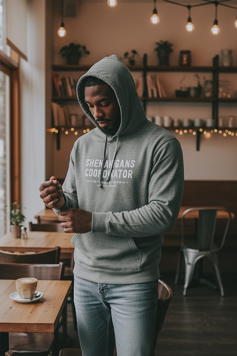 Shenanigans Coordinator Midweight Fleece Hoodie in grey with white ink on an african american man