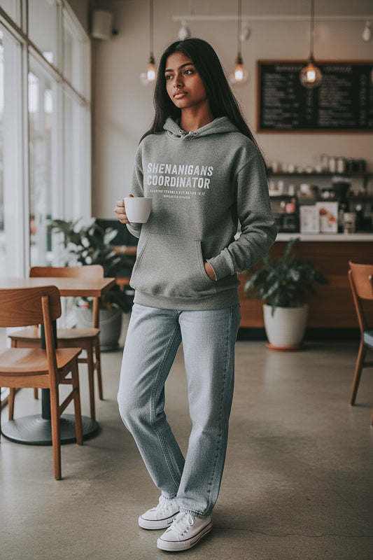 Shenanigans Coordinator Midweight Fleece Hoodie in grey with white ink on an a woman