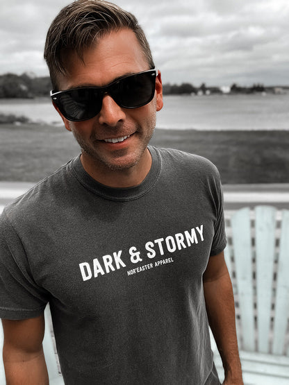 Nor'easter Apparel Dark and Stormy cocktail graphic tee front view on a man smiling wearing sunglasses